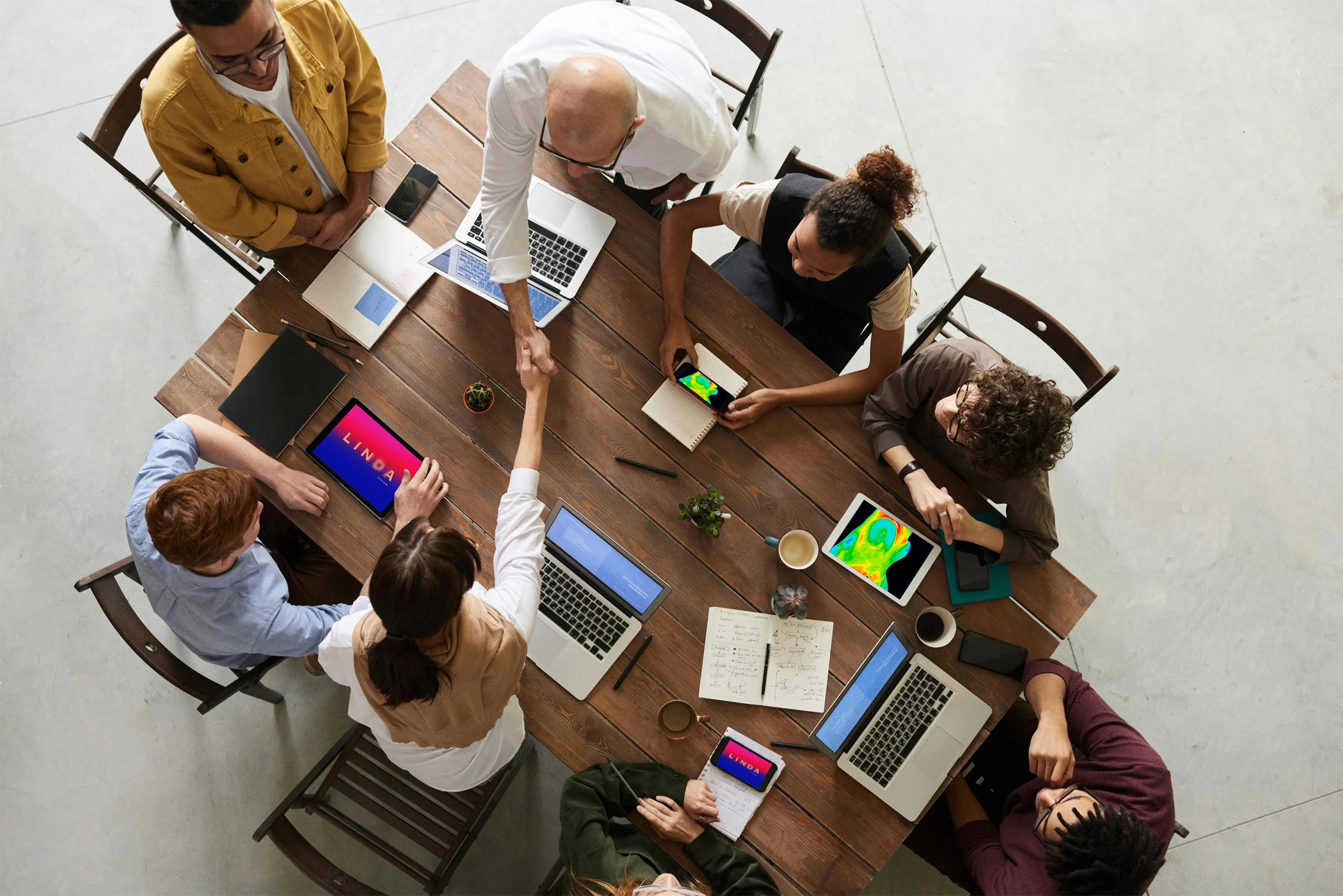 Linda Staff meeting around a conference table